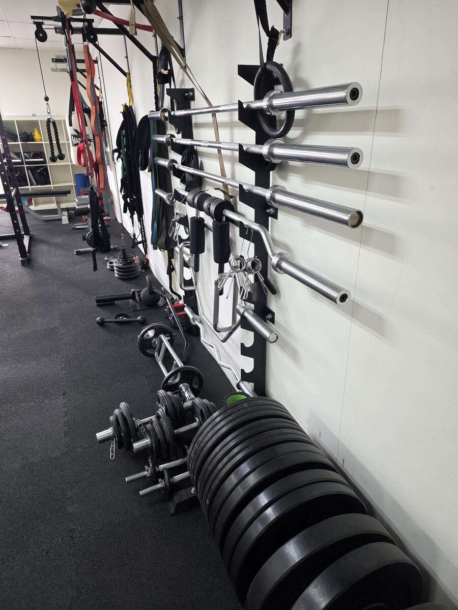 Barbells and bumper plates on the wall rack