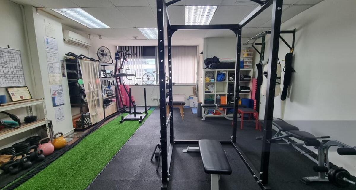 Open training floor with turf lane and functional wall