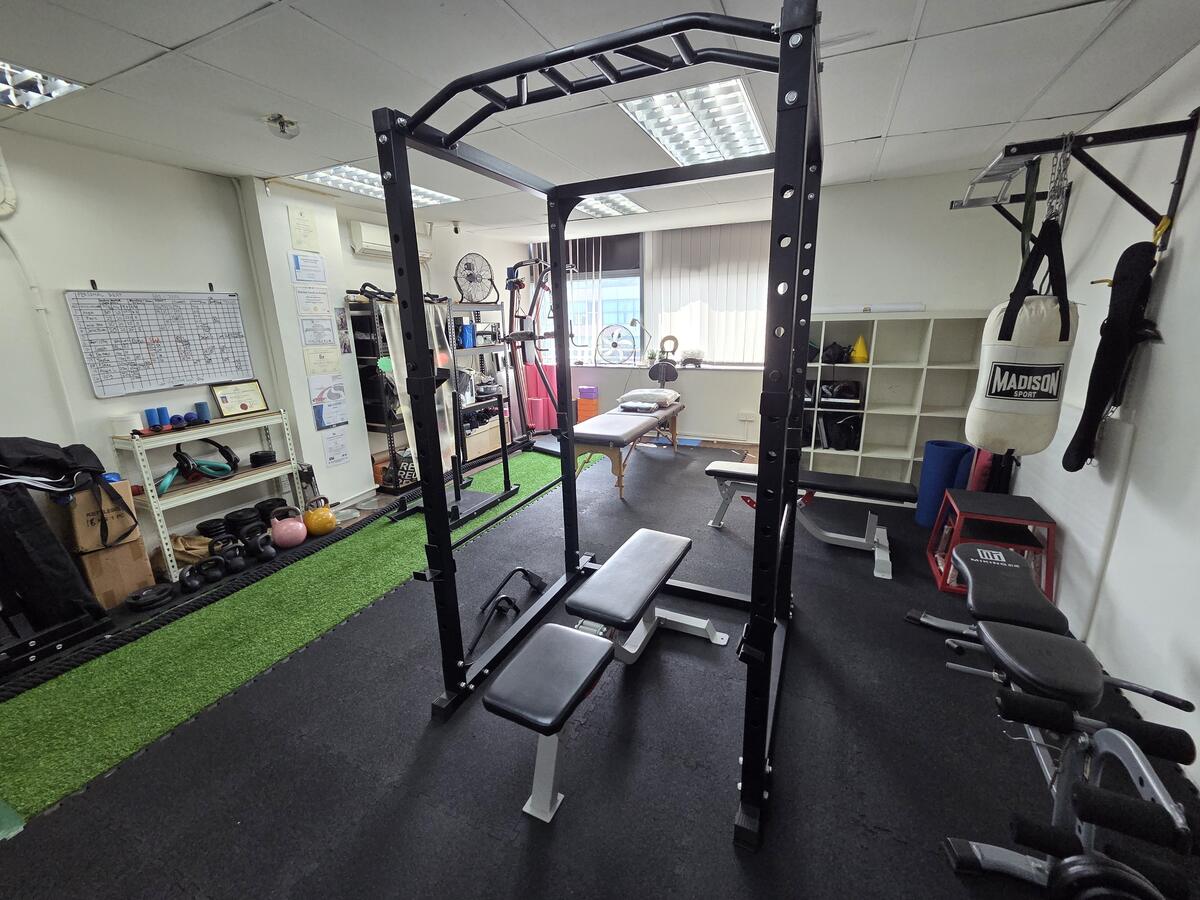 Turf lane with sled, kettlebells and squat stands