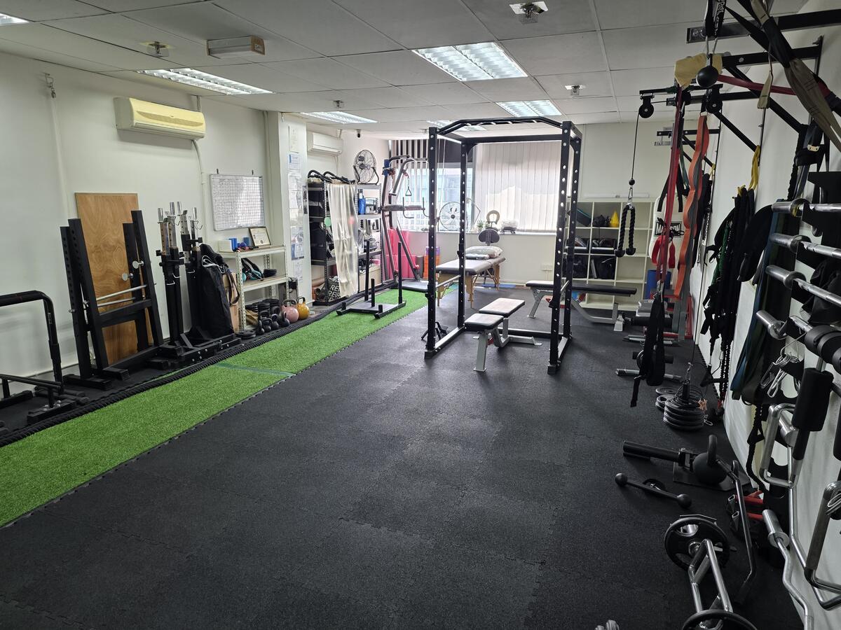 Back of the studio with treatment table and training benches